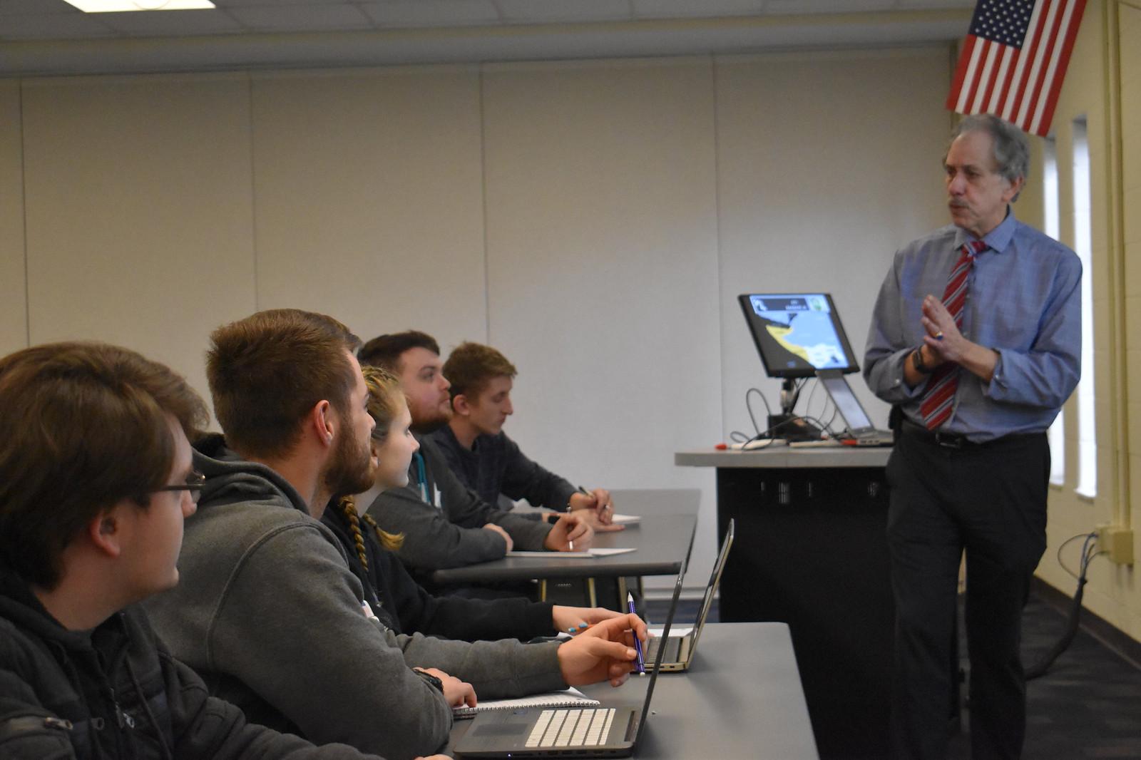 Homeland security students look on as Lou Caprino teaches