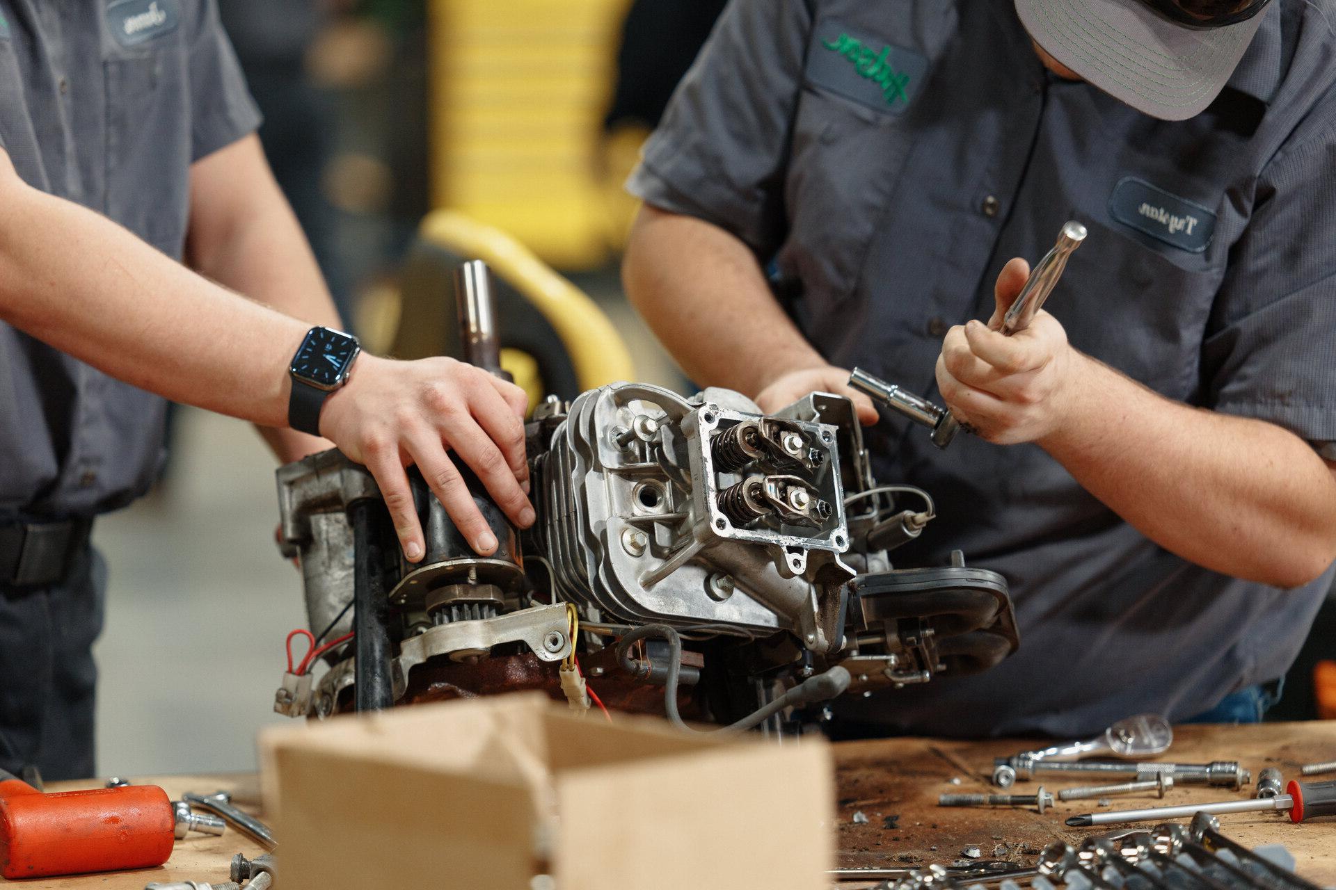 vincennes University students work to repair a diesel engine